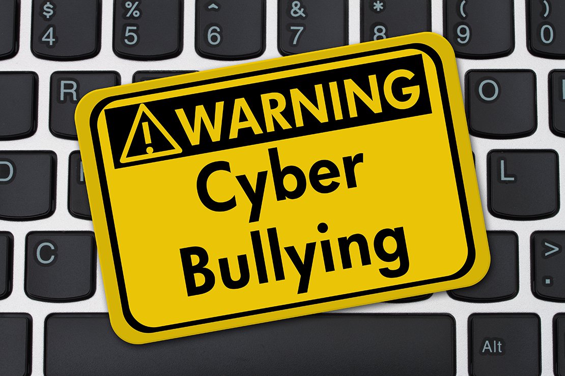 Warning: Cyber Bullying. Sticker on keyboard.