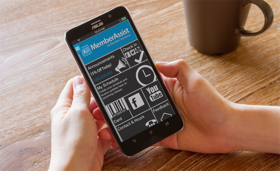 Hands holding mobile device with MemberAssist app