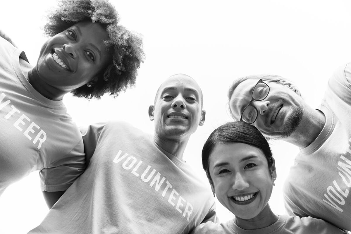 community service volunteers in circle, black & white